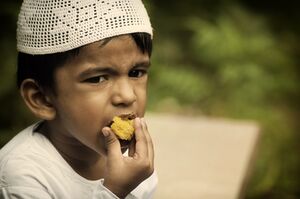 Muslim boy eating during Ramadan.jpg
